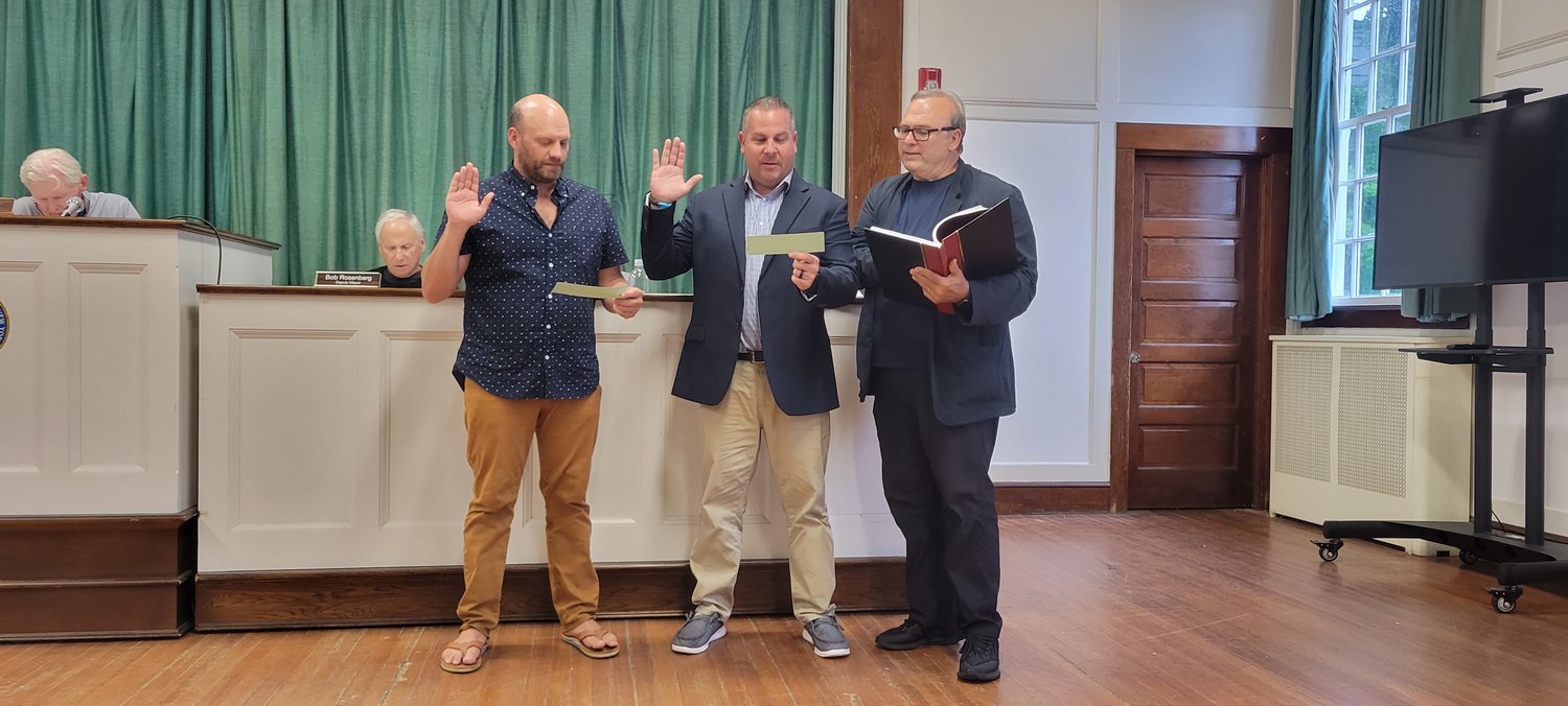 Village clerk John Kocay (right) swears in trustee Steve Mackin (center), who will be serving his fourth term as village trustee, and Nathan Rohrmeier (left), who will be serving his first term as village trustee.